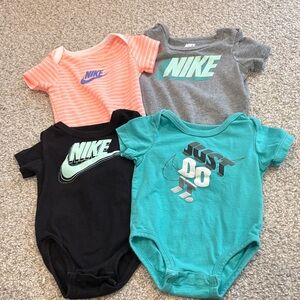 Set of 4 Nike onesies